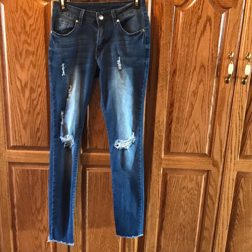 Mid-rise shredded skinny jeans